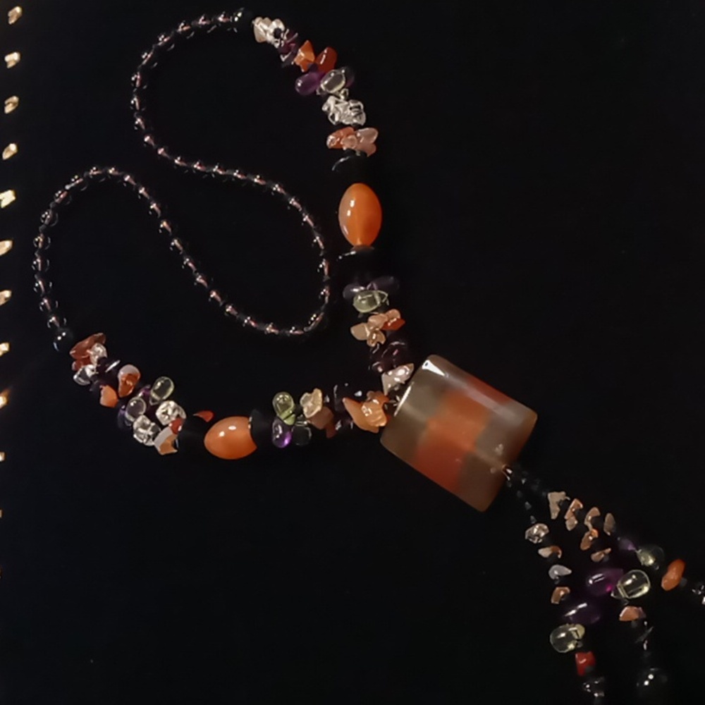 Semi precious & glass beaded tassel necklace with a large carnelian pendent.